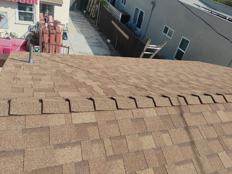 Owens Corning cool roof shingles on a detached garage by Crown Roofing and Repairs Inc