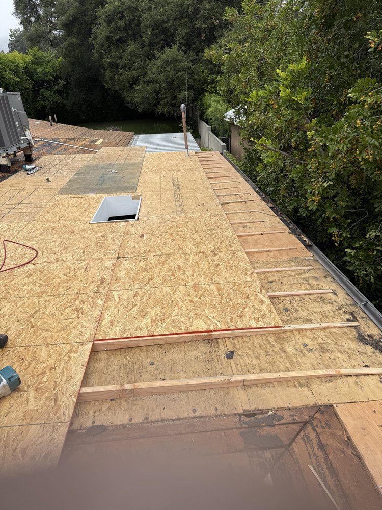 Re-sloping a flat roof section where water kept pooling, plus a new skylight by Crown Roofing and Repairs Inc